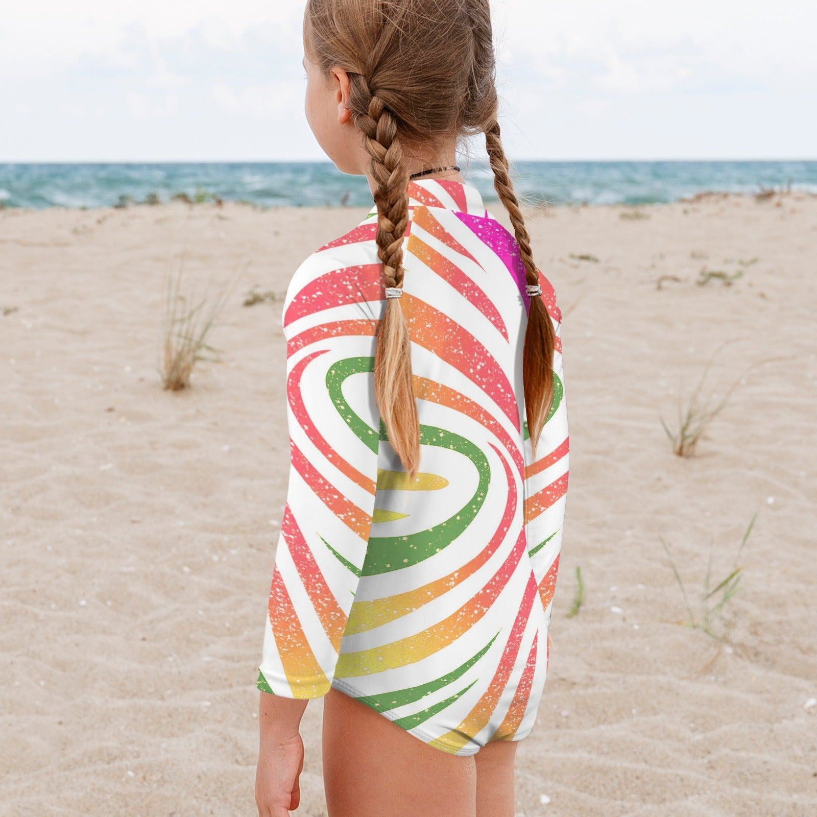 Girl wearing a colorful striped long sleeve one piece on Anna Maria Island Beach.
