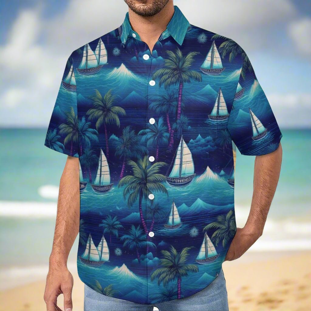 Salty Dude wearing a blue Hawaiian shirt with sailboat and palm tree pattern standing on the beach in Waikiki
