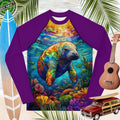 Colorful long-sleeve shirt with a manatee design on a tropical-themed background with surfboard, ukulele, and toy car.