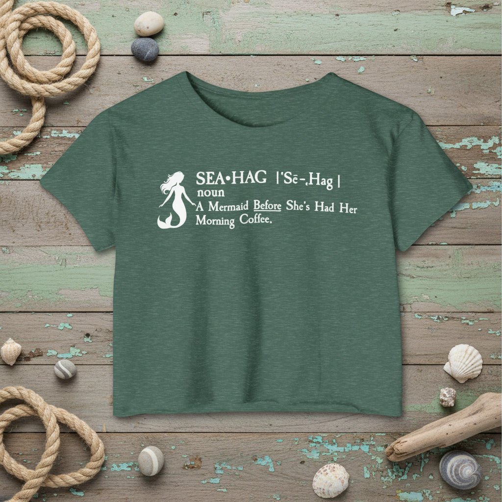 Green t-shirt with mermaid graphic and text on a rustic nautical background