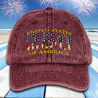 Maroon cap with 'United States 250 of America' text and American flag design on a beach with fireworks background.