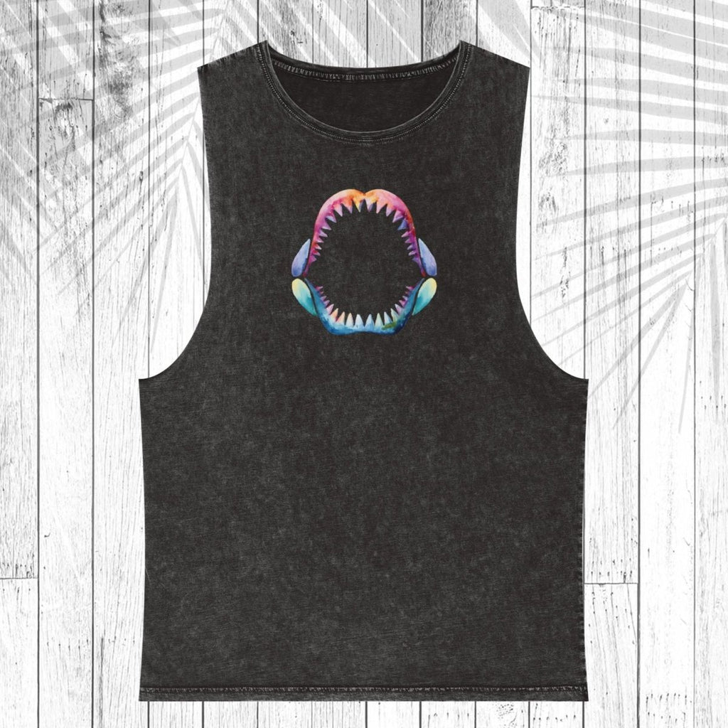 A black washed sleeveless tank top featuring a colorful graphic of an open shark mouth on the chest, displayed flat against a white wood plank background with a palm leaf overlay.