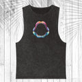 A black washed sleeveless tank top featuring a colorful graphic of an open shark mouth on the chest, displayed flat against a white wood plank background with a palm leaf overlay.