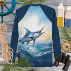 Navy blue long-sleeve rashie with a marlin design on a wooden background with nautical items.