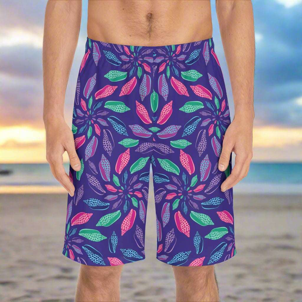 junonia seashell shorts for men worn by a guy standing on a beach looking for rare seashells