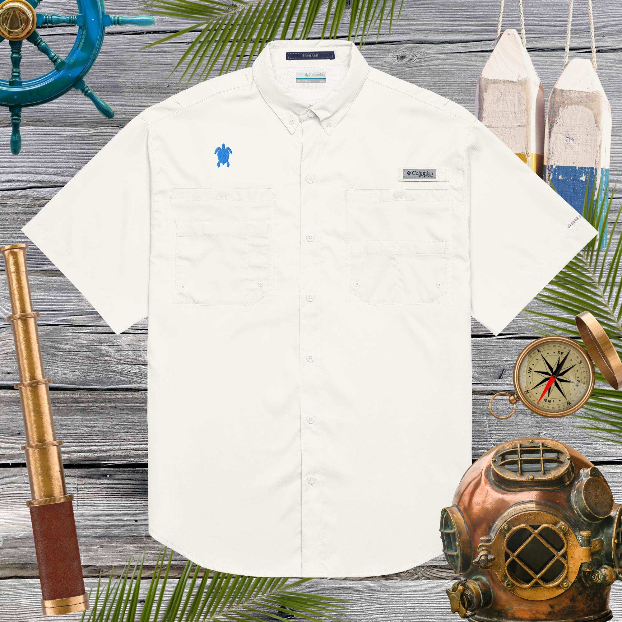 White shirt with embroidered sea turtle on a wooden background with nautical-themed decor