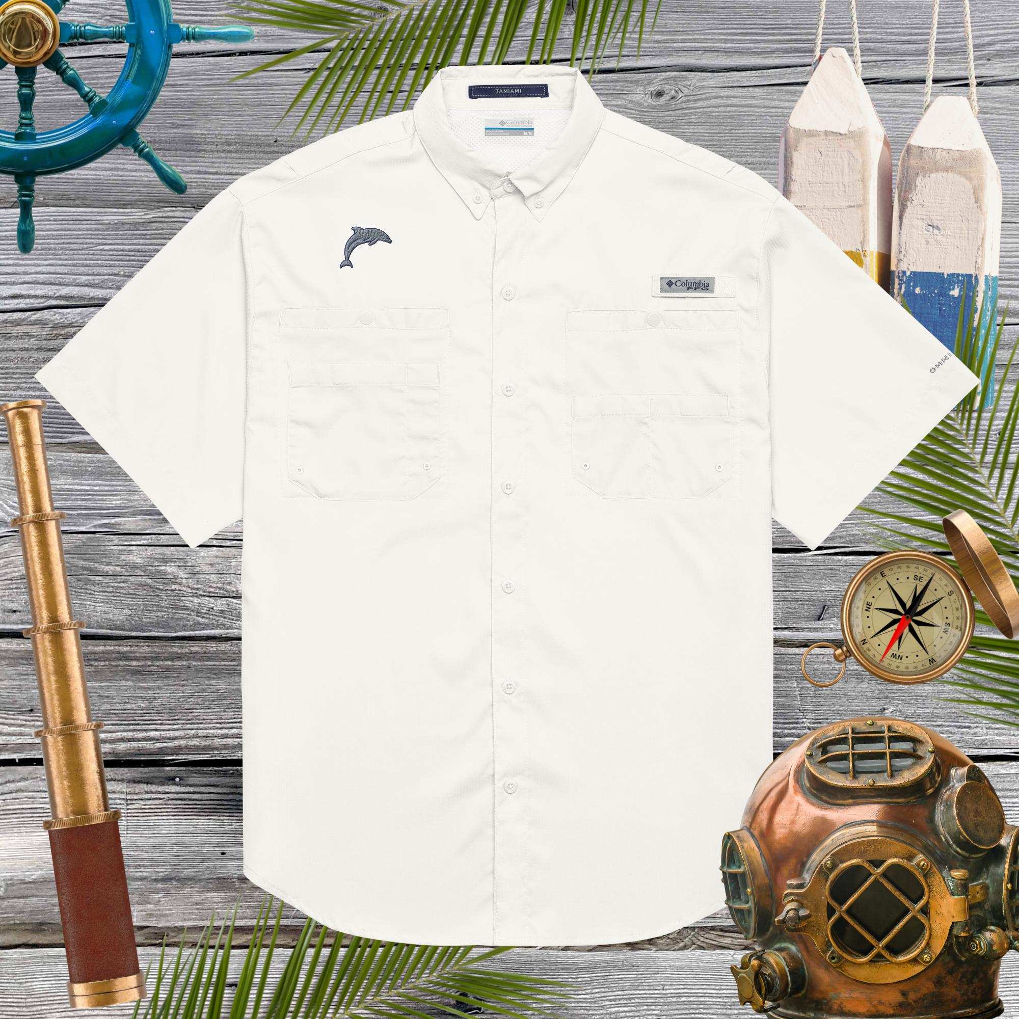 White shirt with embroidered dolphin logo on a wooden background with nautical items