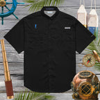 Black short-sleeve shirt with brand logos on a wooden background with nautical-themed decorations.