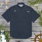 Navy blue short-sleeve shirt with cool shark tooth embroidery on a wooden background with nautical elements.