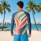 Dude wearing a colorful long-sleeve shirt with abstract design on a white background