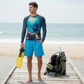Man wearing a long-sleeve rash guard with a ship and treasure chest design on treasure island