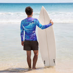 Dude wearing colorful wave pattern swim shirt holding a surfboard on La Jolla beach