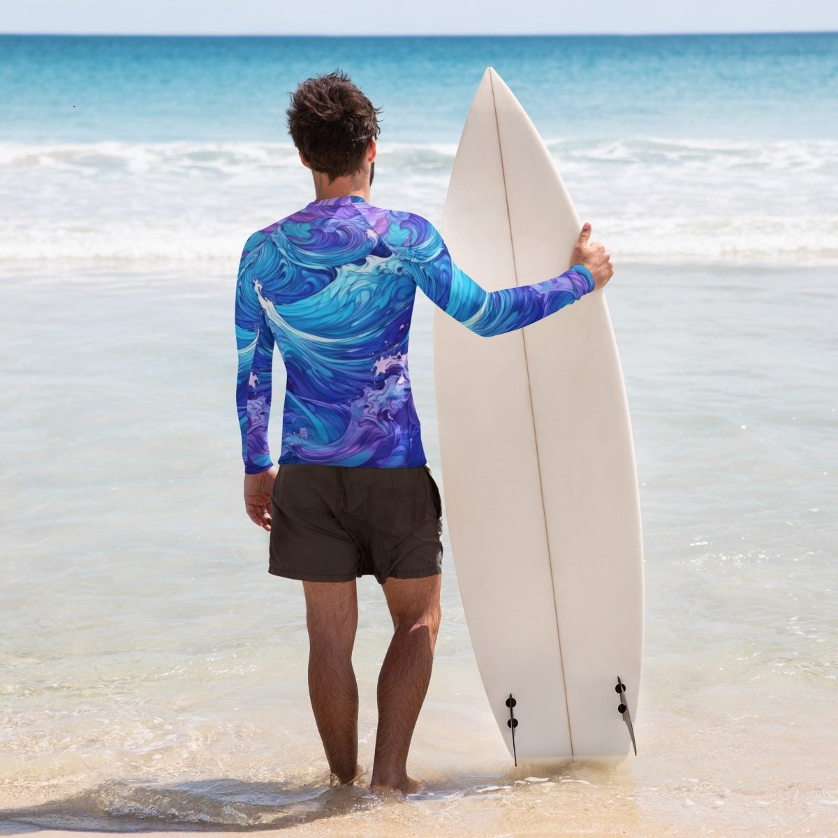 Dude wearing colorful wave pattern swim shirt holding a surfboard on La Jolla beach