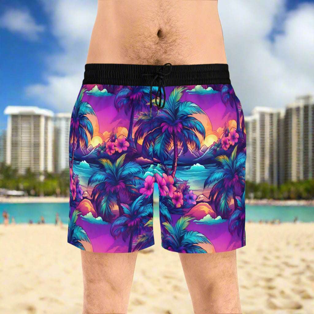 Guy standing on the beach in Waikiki in Hawaiian luau style swim trunks. 