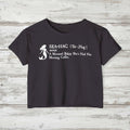Navy blue t-shirt with white mermaid graphic and text on a rustic wood background