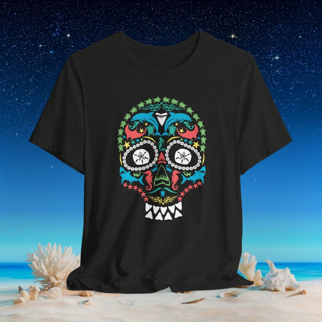 A black short-sleeve t-shirt featuring a colorful ocean life sugar skull graphic on the front, set against a beach and starry night sky background.