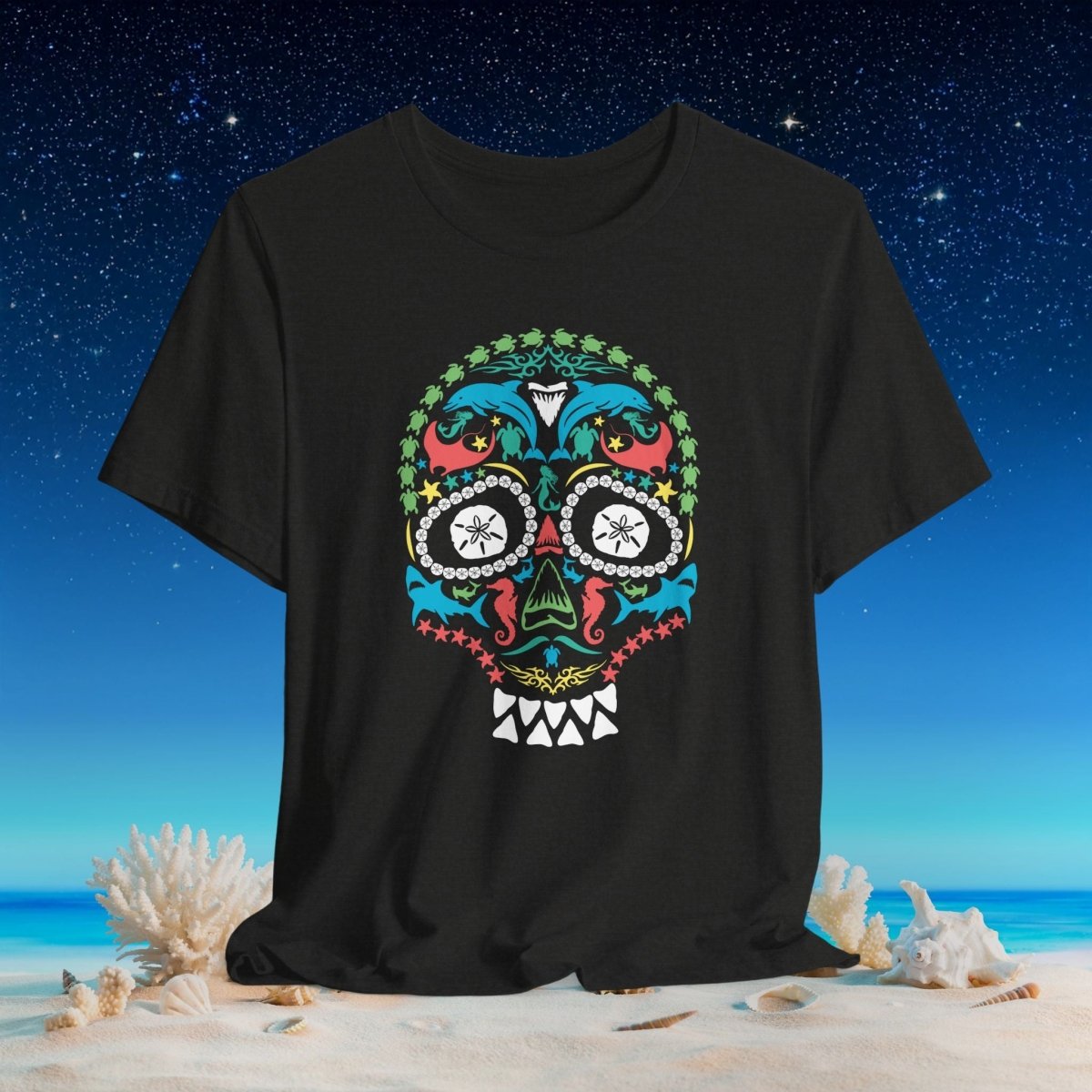 A black short-sleeve t-shirt featuring a colorful ocean life sugar skull graphic on the front, set against a beach and starry night sky background.