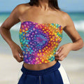 Beachwear Model wearing a colorful strapless top with a spiral tie dye pattern standing on a tropical island beach