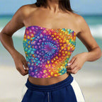 Beachwear Model wearing a colorful strapless top with a spiral tie dye pattern standing on a tropical island beach