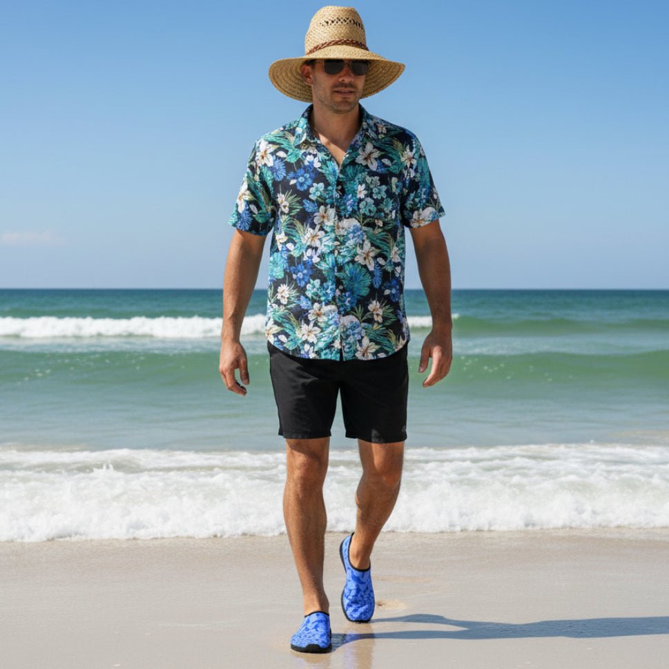Dude wearing blue water shoes and black board shorts and a Hawaiian shirt walking on miramar beach in Destin Florida