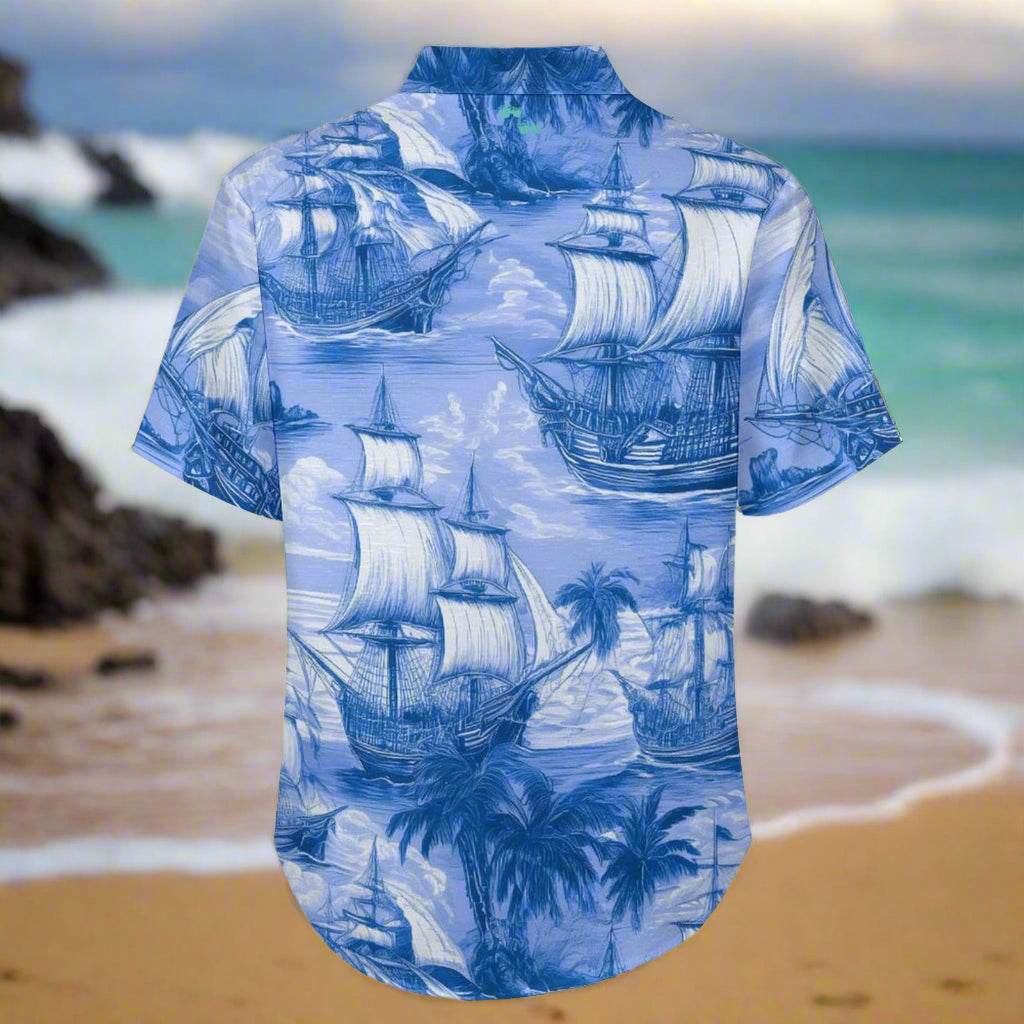 Back of Blue Hawaiian shirt with ship and palm tree pattern on a beach background