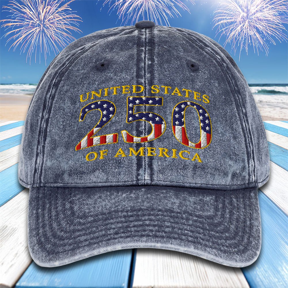 Gray cap with 'United States 250 of America' text and American flag design on a beach with fireworks background