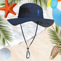 Navy blue seahorse sun hat with a strap on a beach-themed background with palm leaves, starfish, and shells.
