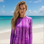 Woman wearing a purple striped Sun Rashie on Ocean Beach with blue sky and the Pacific Ocean.