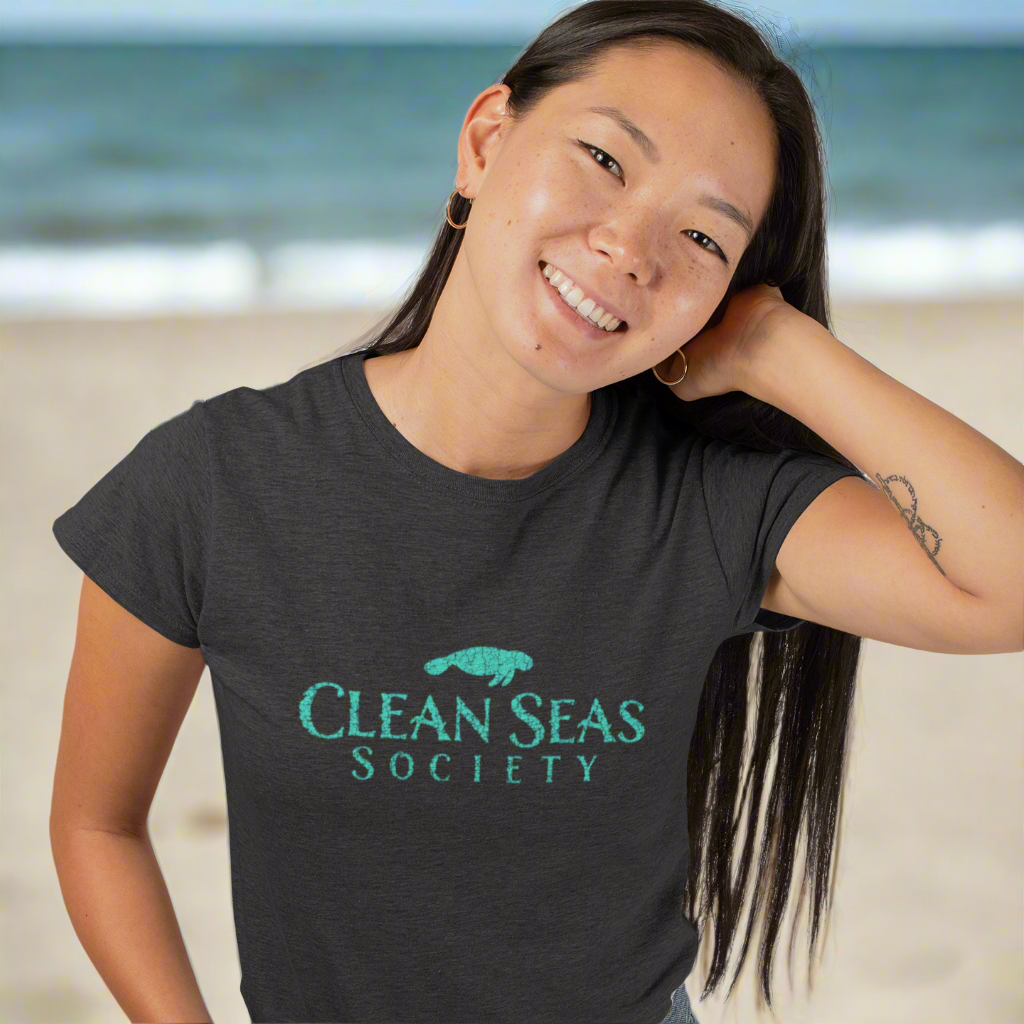 Cute Girl wearing a black t-shirt with 'Clean Seas Society' logo on at a local Beach cleaning party