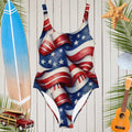 Women's Americana One-Piece swimsuit hanging in front of a rustic wall a a surf shack