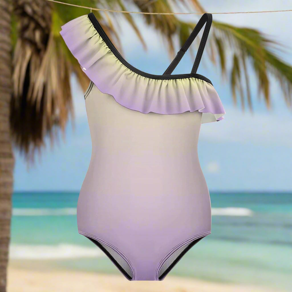 One-piece swimsuit with ruffled shoulder design hanging on a line outside a seaside tiki hut