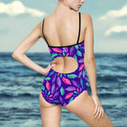 Woman in Cut Out One Piece Swimsuit facing the ocean