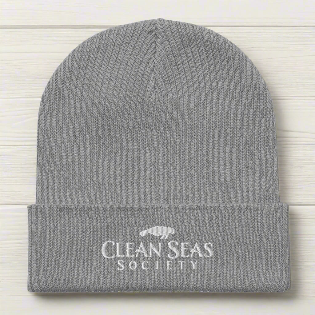 Light Grey Organic Beanie wiht Clean Seas Society logo on a nautical wood background