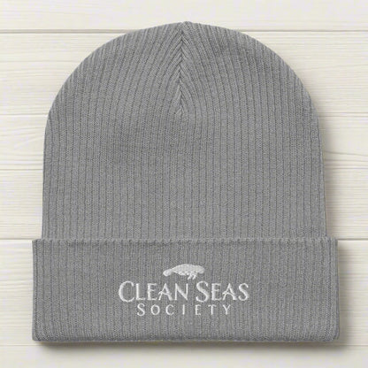 Light Grey Organic Beanie wiht Clean Seas Society logo on a nautical wood background