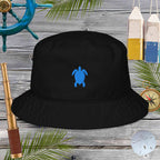 Black bucket hat with a blue turtle logo on a wooden background with nautical items.