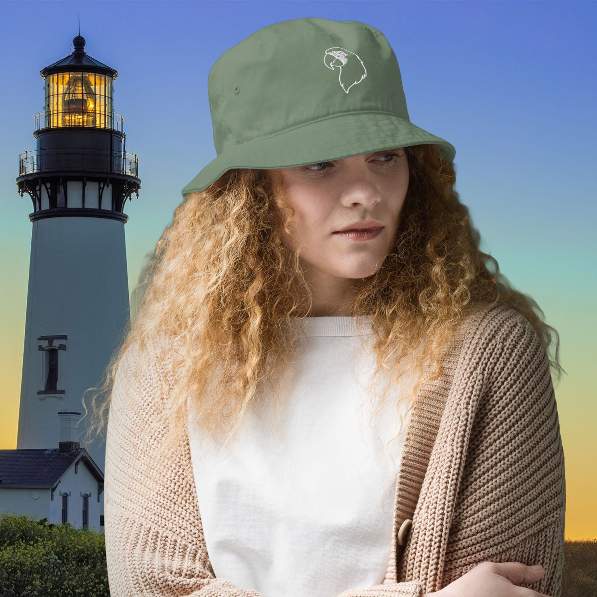 Woman wearing a green bucket hat with a lighthouse in the background