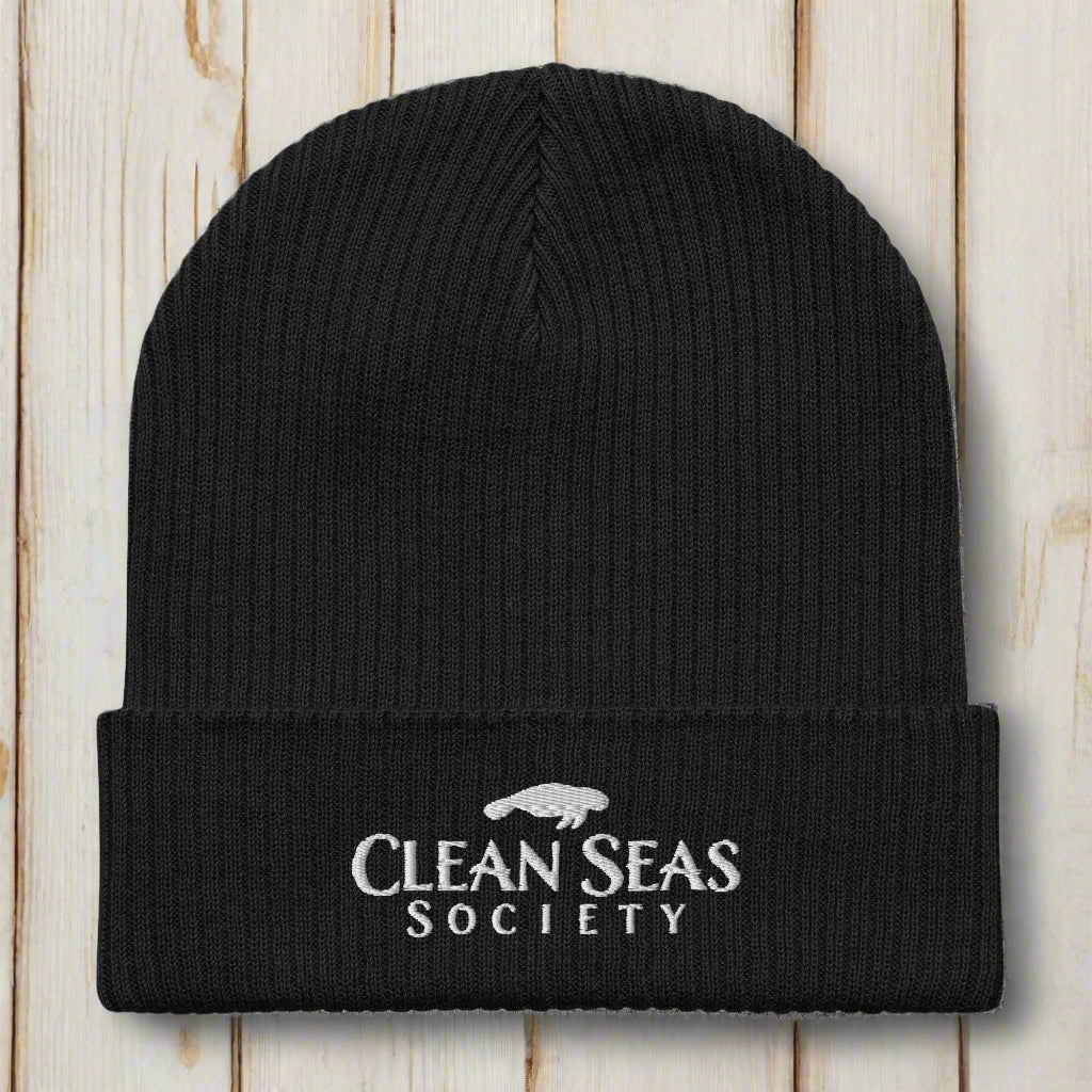Black Organic Clean Seas Beanie on a nautical wood background