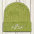 Leaf Green Organic Beanie with Clean Seas Society Logo on a nautical wood background