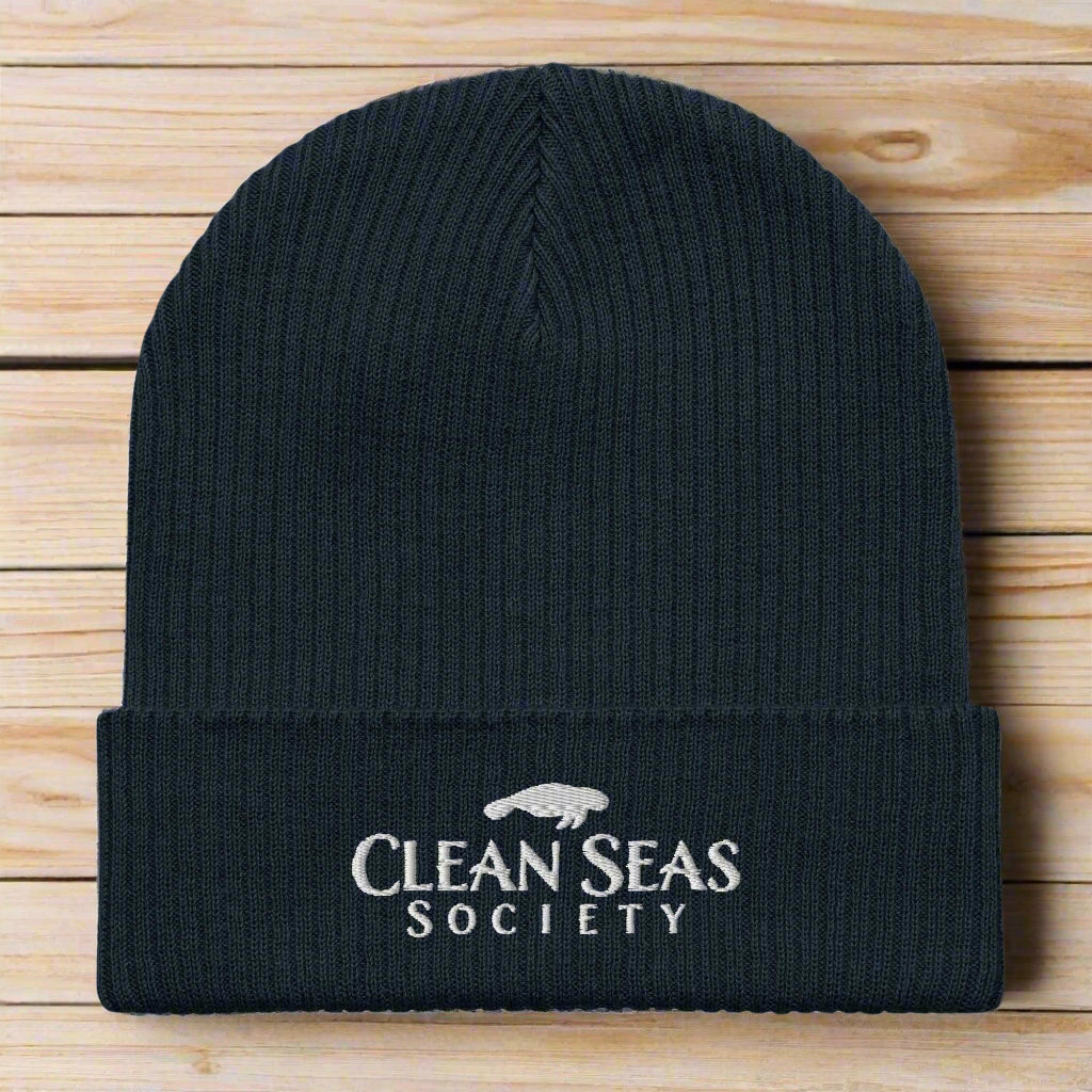 Organic Navy Beanie with Clean Seas Society logo on nautical wood