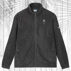 A dark gray fleece zip-up jacket with a stand collar, shown flat against a white wood plank background with a palm leaf pattern overlay. The jacket features a small embroidered  palm tree on the left chest and a small Columbia logo on the right sleeve.
