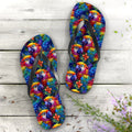 Colorful parrot head flip-flops on a wooden surface with flowers.