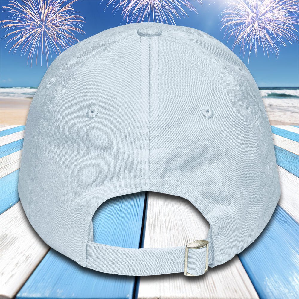 Light blue baseball cap on a beach with fireworks background