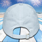 Light blue baseball cap on a beach with fireworks background