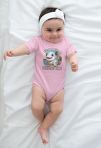 Baby wearing a pink onesie with a cartoon baby shark and feeding time text on a white blanket