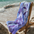 Pink Dolphins on a beach towel draped over a deck chair on the beach