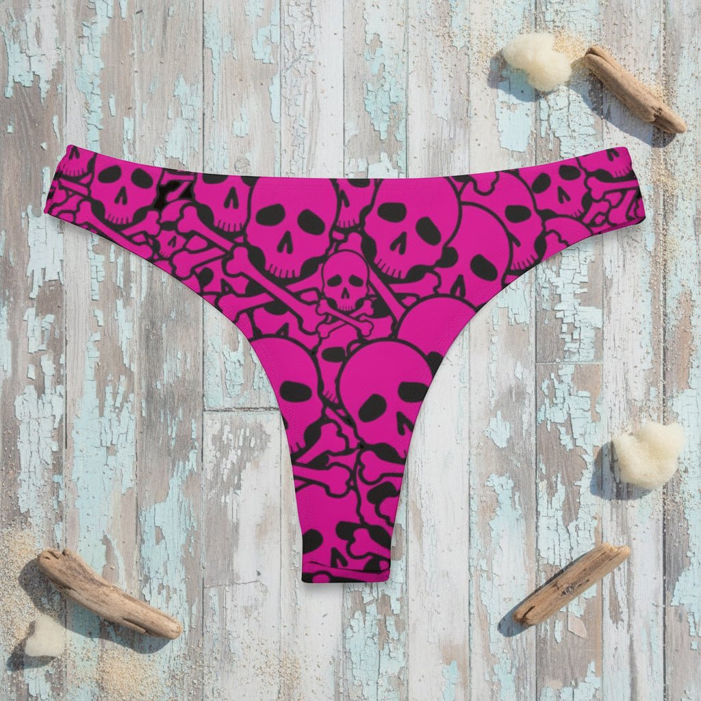 Pink pirate skull pattern bikini with black skull pattern on a rustic wood background