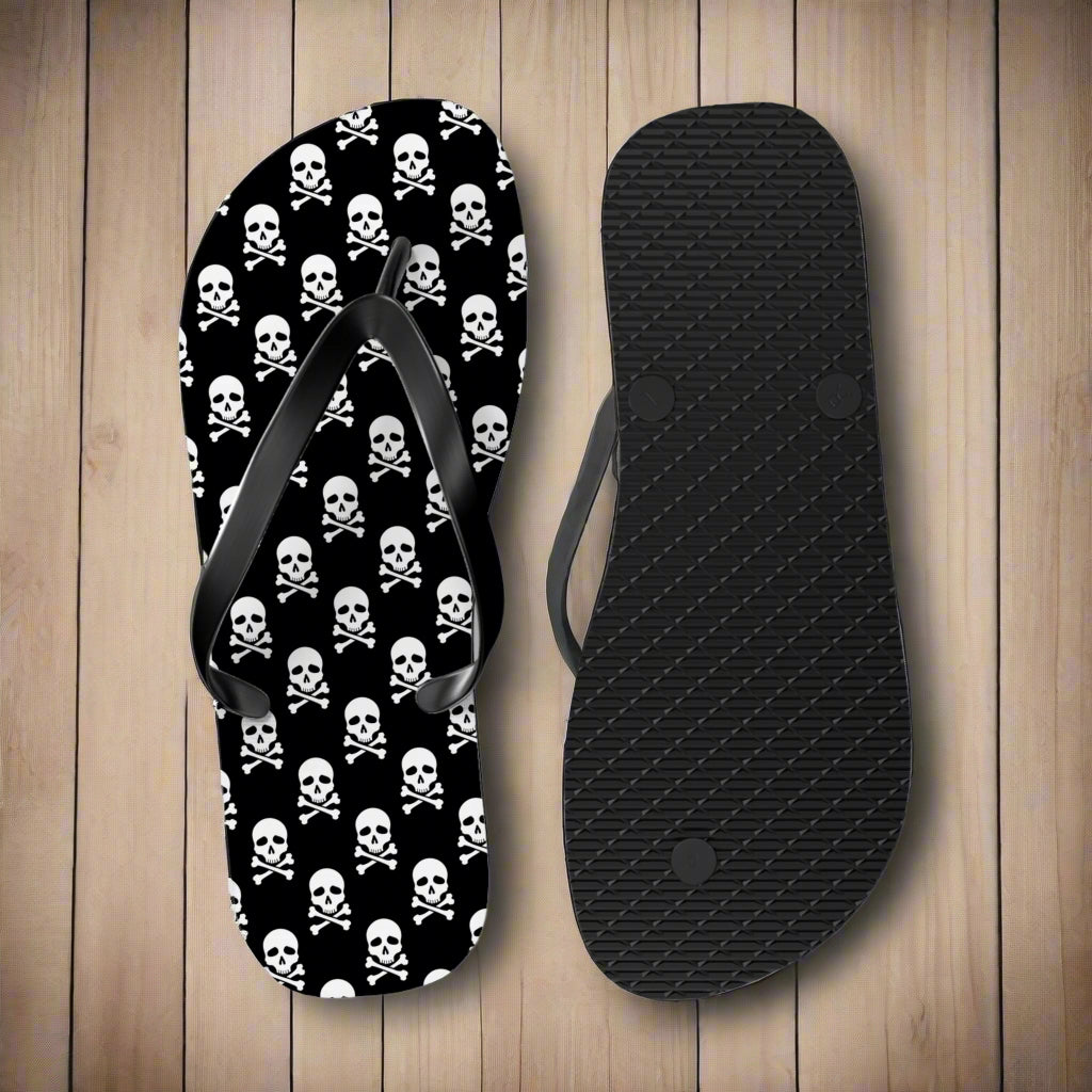 Flip-flop with skull and crossbones pattern and black insole on a nautical wood background