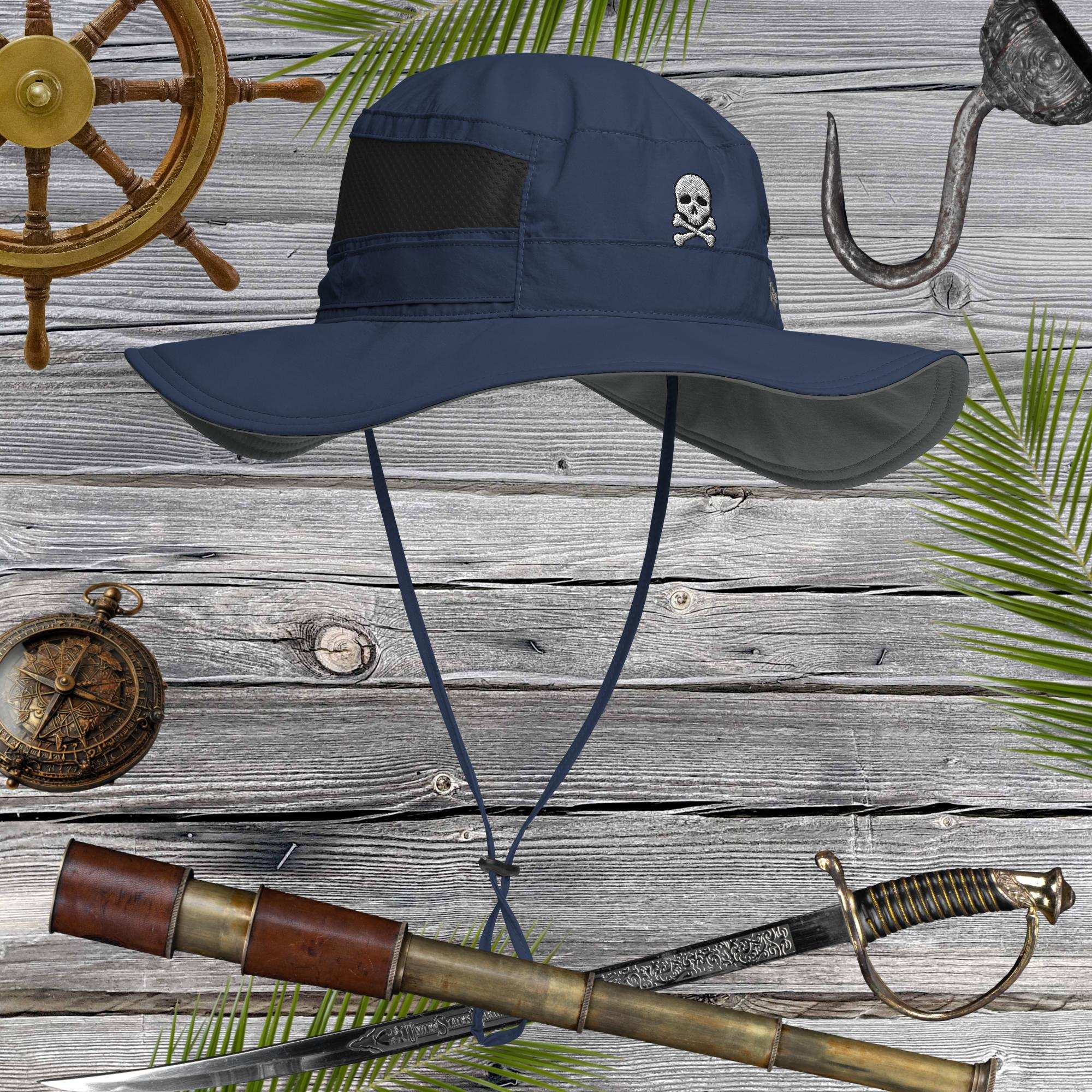 Navy blue sun hat with skull embroidery on a wooden background with pirate-themed items.