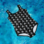 Black swimsuit with skull and crossbones pattern on a blue tiled pool floor.