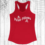 A red racerback tank top with 'Pirate Pillows' printed in white across the chest, displayed on a white wood plank background with a palm leaf overlay.